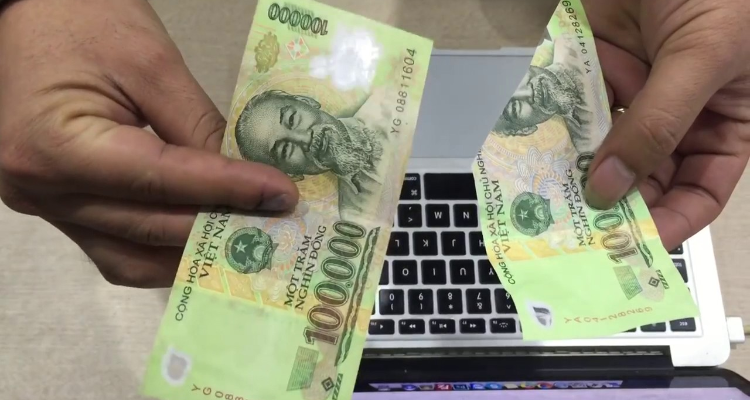 fake money is easily torn - what currency is used in vietnam